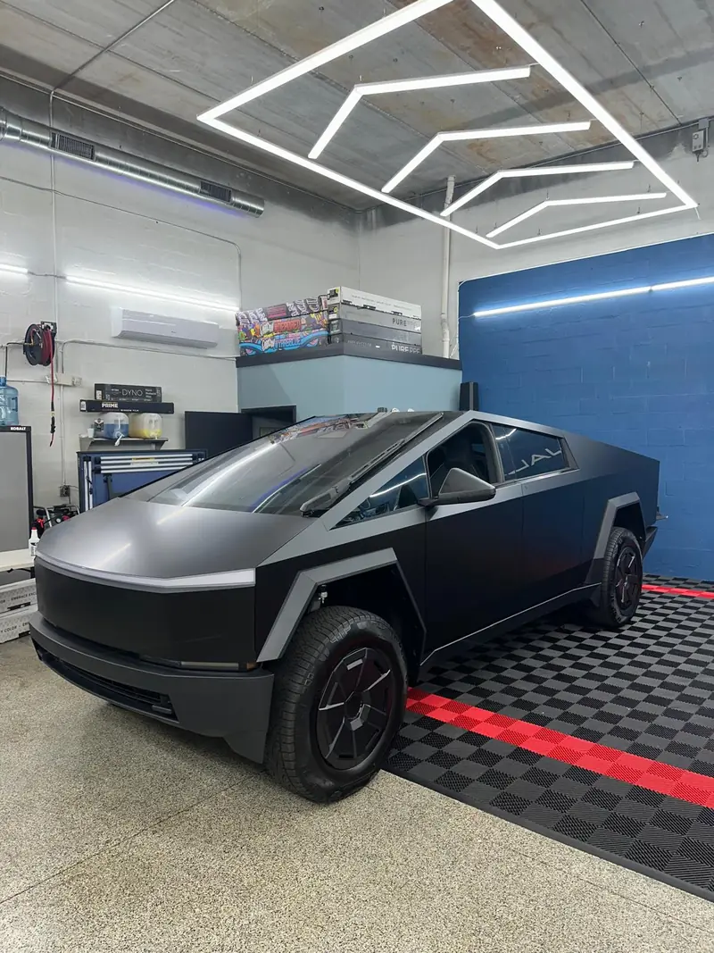 Tesla Cybertruck with a satin black finish in the Stealth Customs bay